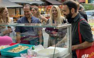 Guide and group of tourists at a market stall