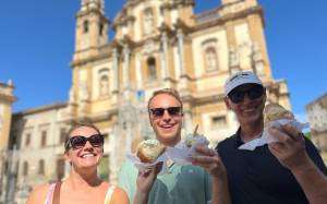 Two men and a woman enjoying brioche with ice cream